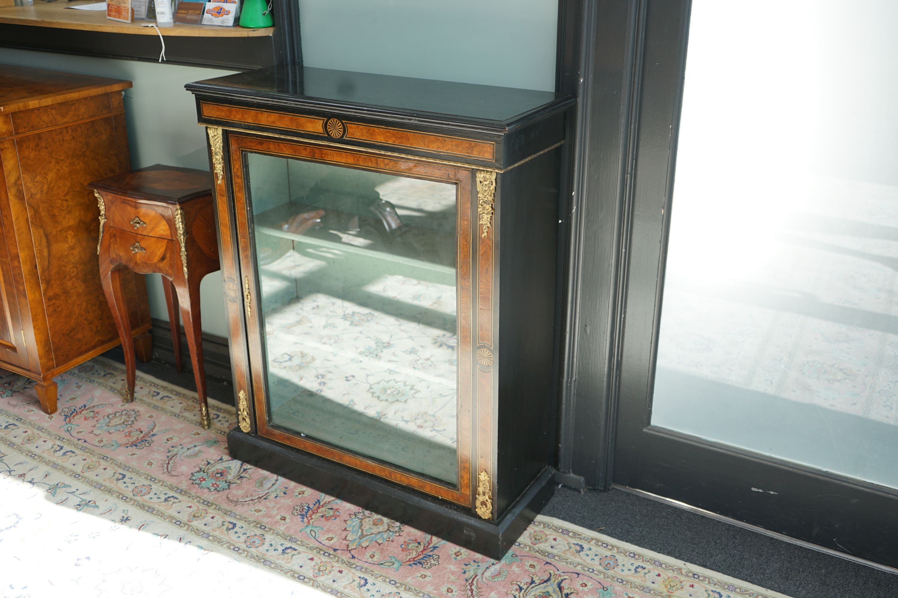 A pair of late Victorian ebonised amboyna banded pier cabinets, width 83cm, depth 32cm, height 100cm